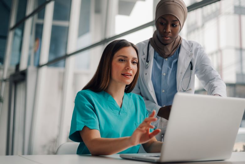 Doctor assisting nurse in the workplace