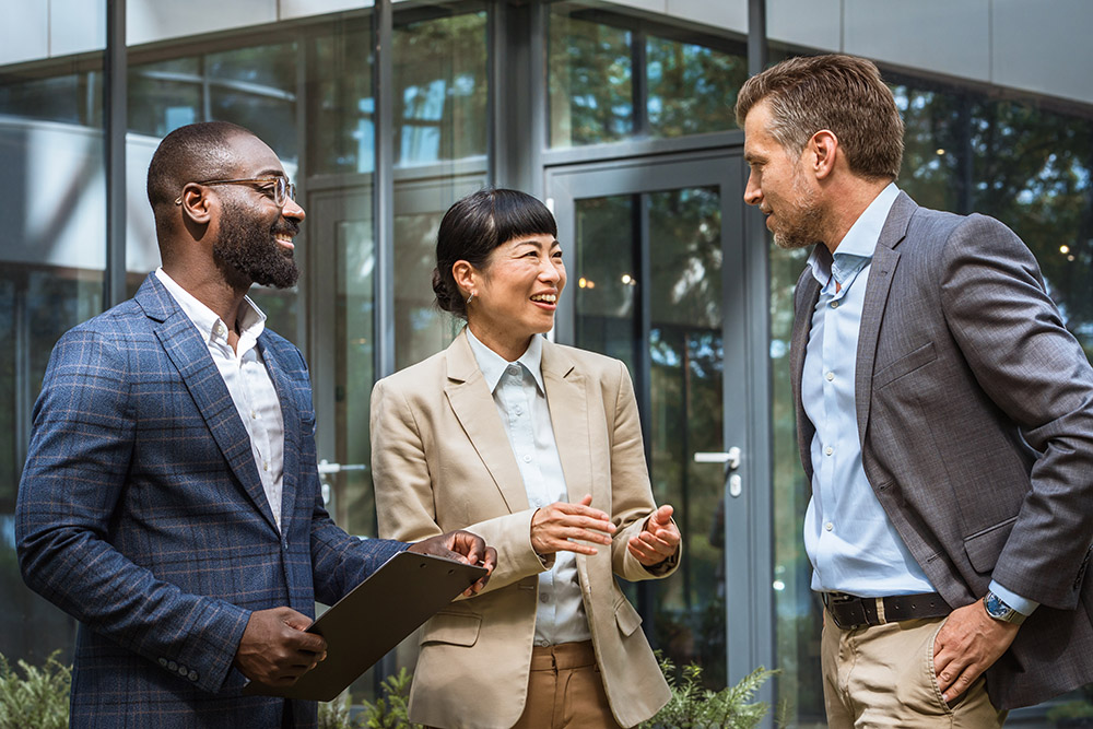 group of professionals talking and smiling