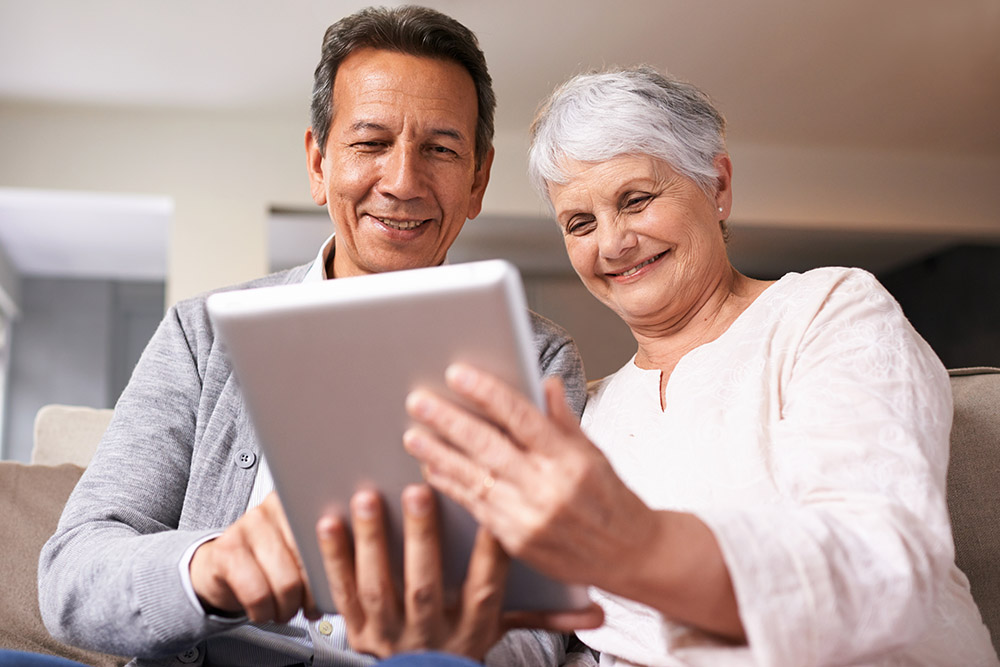 older adults looking at ipad